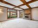 Open living room with a cozy fireplace and large windows offering views of the landscaped backyard at 6744 Robin Hood Ct, Indianapolis, IN 46227