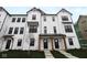 Charming two-story townhome featuring a white exterior, black-trimmed windows, and a covered entryway at 7081 Pate Hollow Dr, Brownsburg, IN 46112