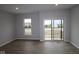 Bright living room features new flooring, natural light and sliding glass door at 7081 Pate Hollow Dr, Brownsburg, IN 46112