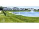 Scenic view of a large pond with fountain, surrounded by lush green grass and modern townhomes at 7081 Pate Hollow Dr, Brownsburg, IN 46112