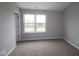 Cozy bedroom featuring a large window offering ample natural light and neutral carpeting at 7085 Pate Hollow Dr, Brownsburg, IN 46112