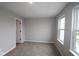 Cozy bedroom with neutral walls, plush carpet, and a window to provide plenty of natural light at 7085 Pate Hollow Dr, Brownsburg, IN 46112