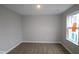 Bright bedroom with hardwood floors, neutral walls, and a window providing natural lighting at 7085 Pate Hollow Dr, Brownsburg, IN 46112