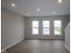 Open living room features recessed lighting, hardwood floors, and large windows for natural light at 7085 Pate Hollow Dr, Brownsburg, IN 46112