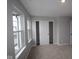 This main bedroom features plush carpet, a closet, and natural light for a relaxing space at 7085 Pate Hollow Dr, Brownsburg, IN 46112