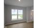 Light-filled bedroom with wood floors and a view of a tranquil pond at 7089 Pate Hollow Dr, Brownsburg, IN 46112
