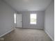 A naturally lit bedroom includes two windows and a door at 7089 Pate Hollow Dr, Brownsburg, IN 46112