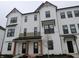 Charming townhome showcasing a bright white exterior with sleek black window trim and dark roofing at 7089 Pate Hollow Dr, Brownsburg, IN 46112