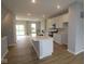 Open-concept kitchen with a central island, stainless steel appliances, and modern white cabinetry at 7089 Pate Hollow Dr, Brownsburg, IN 46112
