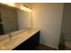 Bathroom featuring a double sink vanity and large well-lit mirror at 7093 Pate Hollow Dr, Brownsburg, IN 46112