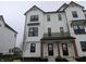 Modern townhome showcases a white facade with black accents and covered entrance at 7093 Pate Hollow Dr, Brownsburg, IN 46112