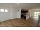 Spacious open-concept layout featuring wood floors that connect to a modern kitchen at 7093 Pate Hollow Dr, Brownsburg, IN 46112