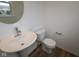 Stylish powder room with modern fixtures including a pedestal sink and round mirror at 7093 Pate Hollow Dr, Brownsburg, IN 46112