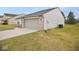 Attached two-car garage and concrete driveway of this home with white siding and brick accents at 788 Tulip Ln, Greenwood, IN 46143