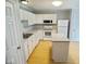 Bright kitchen featuring white cabinets, an island, updated appliances, and wood-look flooring at 788 Tulip Ln, Greenwood, IN 46143