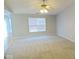 Spacious living room with plush carpeting, large window with blinds, and neutral wall paint at 788 Tulip Ln, Greenwood, IN 46143