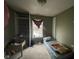 Modest bedroom featuring a single bed, desk, and closet space, illuminated by natural light from a window at 8033 Lake Tree Cir, Indianapolis, IN 46217