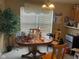 Casual dining area featuring a round table, wooden chairs, and natural lighting at 8033 Lake Tree Cir, Indianapolis, IN 46217