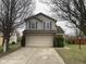 Two-story home with a wide driveway leading to a two-car garage at 8033 Lake Tree Cir, Indianapolis, IN 46217