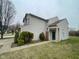 Charming two-story home with a manicured lawn and an attached two-car garage at 8033 Lake Tree Cir, Indianapolis, IN 46217