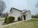 Charming two-story home with a manicured lawn and an attached two-car garage at 8033 Lake Tree Cir, Indianapolis, IN 46217