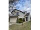 Charming two-story home with a manicured lawn and an attached two-car garage at 8033 Lake Tree Cir, Indianapolis, IN 46217