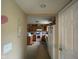 Kitchen view from hall showing wooden cabinets, appliances, and window; door on right at 8033 Lake Tree Cir, Indianapolis, IN 46217