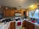 Functional kitchen equipped with wooden cabinets, standard appliances, and a window over the sink at 8033 Lake Tree Cir, Indianapolis, IN 46217
