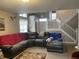 Comfortable living room with staircase, plush sofa, and a decorative rug at 8033 Lake Tree Cir, Indianapolis, IN 46217