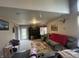Spacious living area with TV, seating, rear yard access and natural light at 8033 Lake Tree Cir, Indianapolis, IN 46217