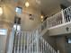 Bright foyer with white staircase and railing leading to the second floor at 8033 Lake Tree Cir, Indianapolis, IN 46217