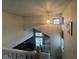 Carpeted staircase with white railing and views to the living room with natural light from the windows at 8033 Lake Tree Cir, Indianapolis, IN 46217