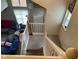 Carpeted staircase with white railing and views to the living room with natural light from the windows at 8033 Lake Tree Cir, Indianapolis, IN 46217