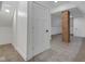 Spacious attic featuring a brick support beam, white trim and doors, and fresh neutral carpet at 843 N Oxford St, Indianapolis, IN 46201