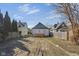 View of the backyard of a home featuring neighboring houses and a patch of trees at 843 N Oxford St, Indianapolis, IN 46201
