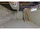 Unfinished basement space with exposed beams and block walls; great for storage and improvements at 843 N Oxford St, Indianapolis, IN 46201