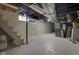 Spacious unfinished basement with painted walls, open ceiling, and plenty of room for storage at 843 N Oxford St, Indianapolis, IN 46201