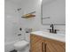Updated bathroom with bright tiles and wood vanity with marble countertop at 843 N Oxford St, Indianapolis, IN 46201