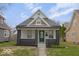 Charming home with a well-manicured lawn, appealing front door, and attractive architectural details at 843 N Oxford St, Indianapolis, IN 46201