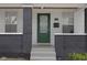 Close up of house's entry way with a decorative front door, stylish brick pillars, and painted stairs at 843 N Oxford St, Indianapolis, IN 46201