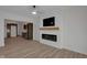 Comfortable living room featuring a modern electric fireplace, hardwood floors, and a view of the kitchen at 843 N Oxford St, Indianapolis, IN 46201