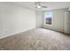 Bright bedroom with neutral carpet and walls, a ceiling fan, and a window at 912 Springside Ct, Greenfield, IN 46140