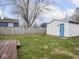 Spacious backyard with green grass, wooden fence and shed at 928 E Pleasant Run Parkway North Dr, Indianapolis, IN 46203