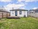 Backyard featuring a small deck, grass and partial fence at 928 E Pleasant Run Parkway North Dr, Indianapolis, IN 46203