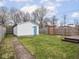Spacious backyard with green grass, wooden fence and shed at 928 E Pleasant Run Parkway North Dr, Indianapolis, IN 46203