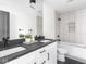 Modern bathroom featuring a double vanity, black fixtures, and a shower-over-tub at 928 E Pleasant Run Parkway North Dr, Indianapolis, IN 46203