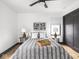 Bedroom featuring wood floors, minimalist decor, and a ceiling fan at 928 E Pleasant Run Parkway North Dr, Indianapolis, IN 46203