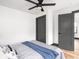 Bedroom featuring a ceiling fan, hardwood floors, neutral decor, and gray baseboards at 928 E Pleasant Run Parkway North Dr, Indianapolis, IN 46203
