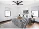 Cozy bedroom featuring wood floors, a ceiling fan, and minimalist decor at 928 E Pleasant Run Parkway North Dr, Indianapolis, IN 46203