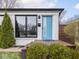 Close up of a bright blue front door framed by black trim and lush landscaping at 928 E Pleasant Run Parkway North Dr, Indianapolis, IN 46203